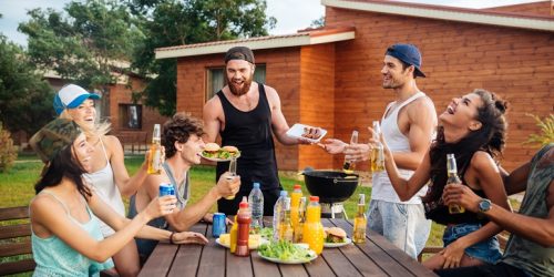 Happy young people laughing and having fun on barbeque party