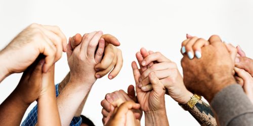 closeup-diverse-people-holding-hands