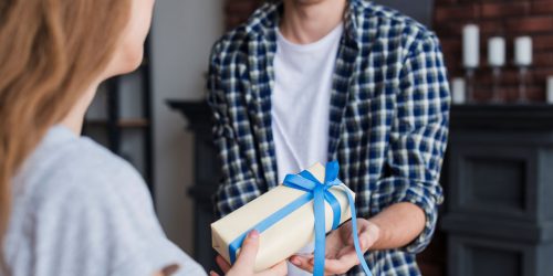 young-female-giving-gift-husband